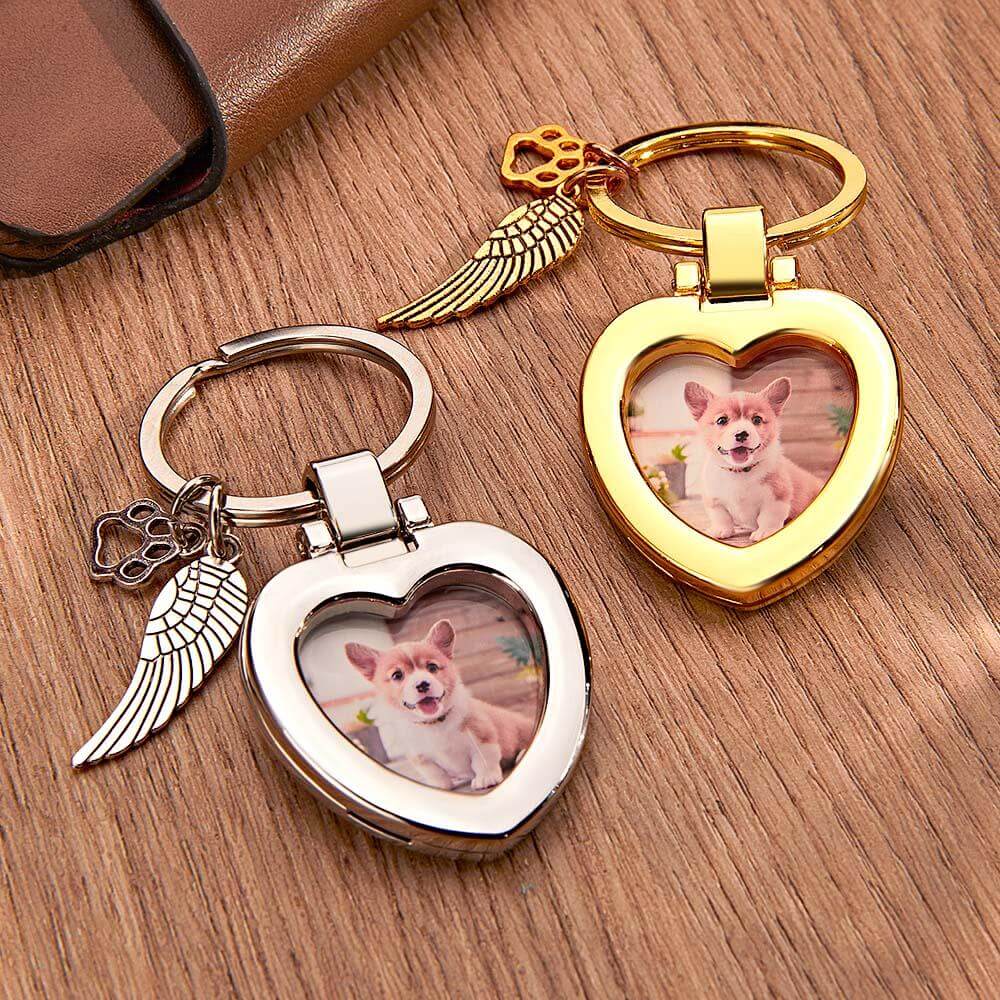 Gold and silver custom photo pet keychains with charms side by side on table
